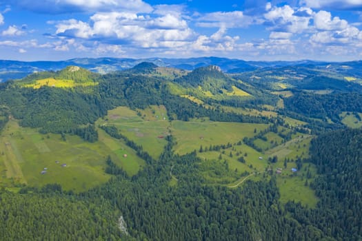 Aerial mountain pasture in a summer landscape from drone