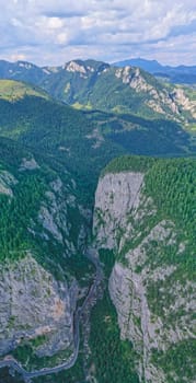 Rocky mountain pass in Romanian Carpathians, highway road between huge rocks, aerial mountain view