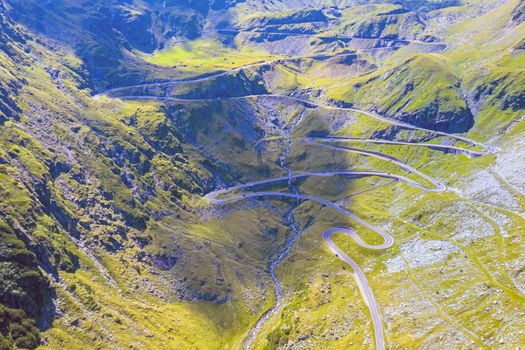 Winding road uphill  on mountain, aerial view of Transfagarasan road in Romania