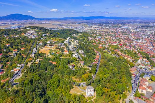 Brasov city viewed from Tampa Hill, summer aerial view in Romania.