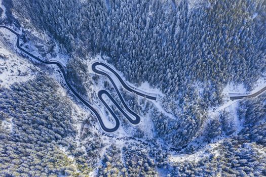 Winter serpentine in rocky mountain forest. Bicaz gorge is a narrow pass between two historical Romanian region.