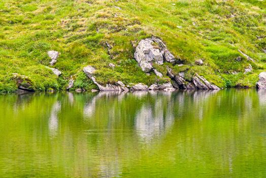 Summer rocky lake mirroring on the mountain, Romanian Carpathians