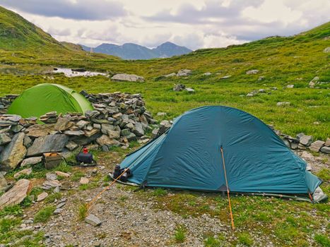 Altitude tents in summer mountain scene, Romanian Carpathians, near glacier lake