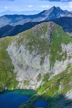 Rock crests on mountains in the summer. Capra Lake in Romanian Carpathians.