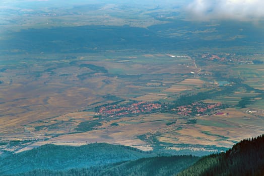 Aerial view from the top of Fagaras Mountains, summer villages and fields