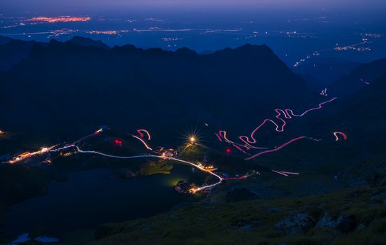 Spectacular mountain road in the night, lights on winding road, Transfagarasan road in Romania, night scene