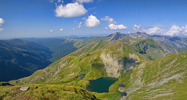 Summer alpine mountain scene with glacier lake of Capram Fagaras Mountains in Romania