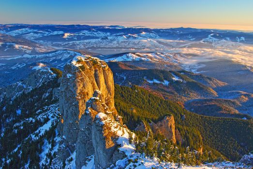 Mountain panorama from the top in winter, aerial landscape in Romanian Carpathians.