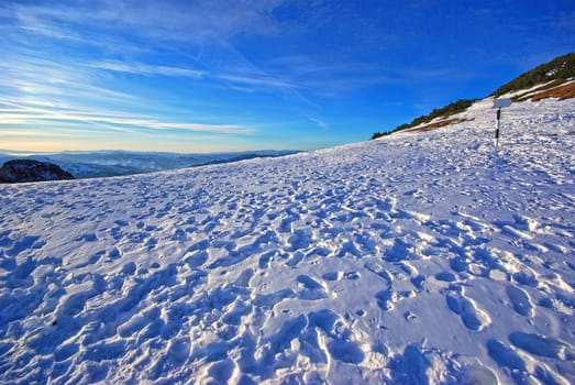 People footprints on the snow, winter mountain scene