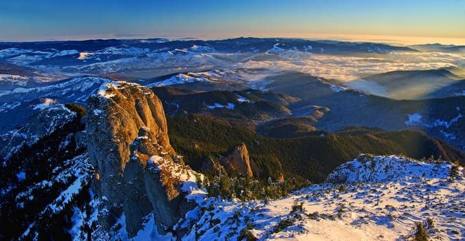 Mountain panorama from the top in winter, aerial panorama in Romanian Carpathians.