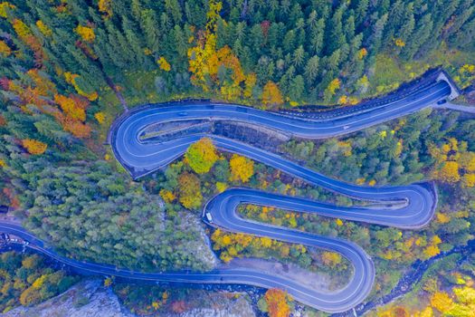 Above view of winding road in autumn forest. Bicaz Gorges are a mountain pass between two historic region in Romania.