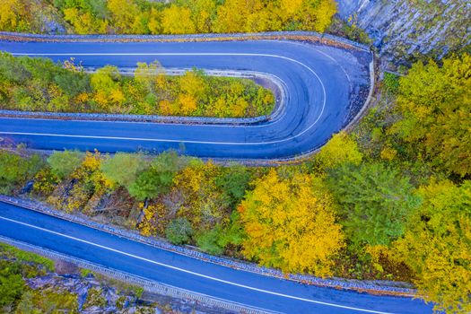 Mountain road in colored forest. Bicaz Gorges are a mountain pass between two historic region in Romania.