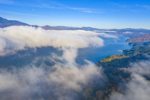 Cloud of mist over mountain lake in Romanian Carpathians.