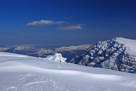 Mountain rock summit landscape. White mountain top in Romanian Carpathians, winter scene.