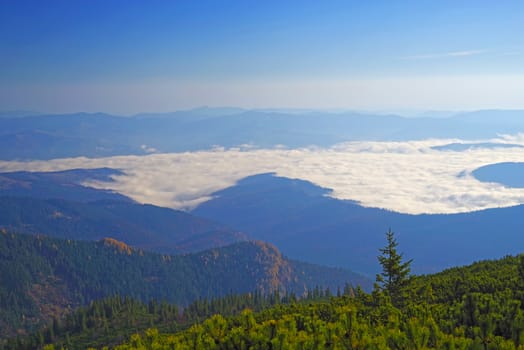 Morning mountain landscape, low clouds  or fog over the river valley.