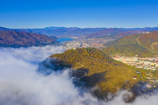 Comming fog over the mountain city, aerial autumn landscape of Piatra Neamt city