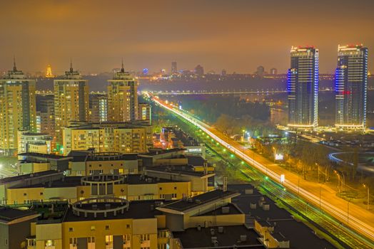 Night Kiev city, panorama of modern buildings and city lights
