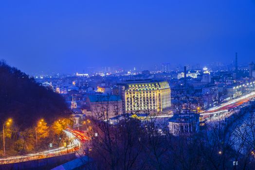 Night panorama of Dnieper river and district of Podil in Kiev