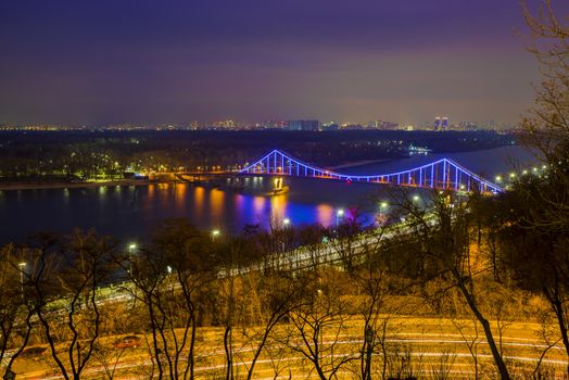 Aerial Dnieper river view and Patona bridge in night, Kiev landscape