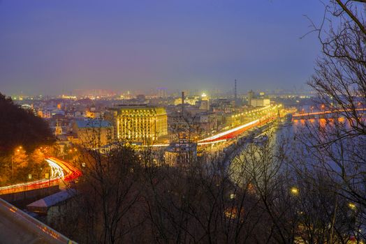 Beautiful night view of Dnieper river and historic district of Podil in Kiev.