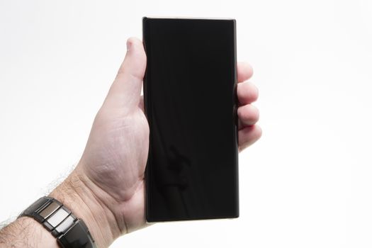 Hand held generic phone over white, black smartphone