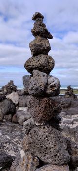 A block of wish rocks of black color on the shore of hyeopjae beach in Jeju Island, South Korea.