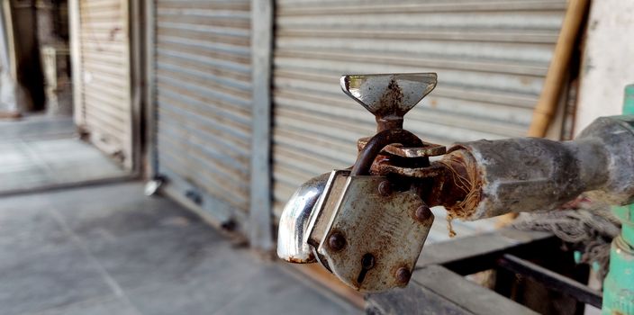 A tap of water with a rusty lock in area of water shortage during lock down in Indian during quarantine because of corona virus