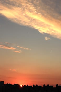 Pink blue gradient sky on a silhouette background of a house roof in a sleeping area.