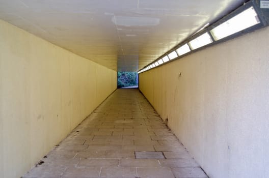 View through a pedestrian subway underneath a busy road in Basingstoke, Hampshire.