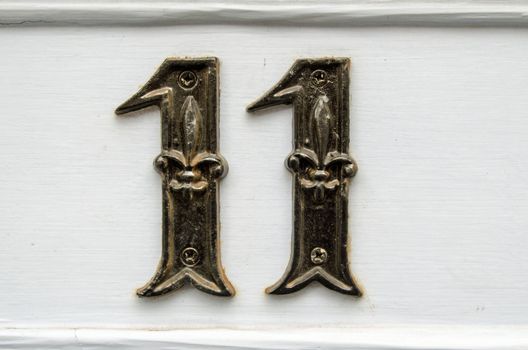 Number eleven screwed to the outside of a front door.