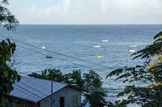 Evening view of Castara Bay, Tobago with fishing boats moored in the sunshine.