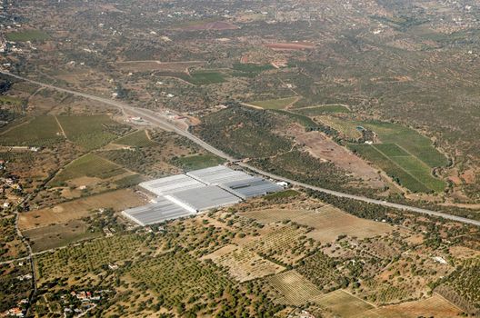 Aerial view of greenhouses operated by the Hubel Company in Fazenda Nova in the Faro region of Portugal  The A22 road cuts through the landscape.