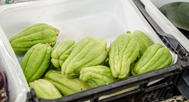 The vegetable known in Portugal as Chuchu and in Latin America as Chayote for sale on a market stall in Monte Gordo, Portugal.  The squash is best eaten either pickled or cooked.