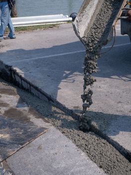 The Builders pouring cement during Upgrade to residential street.