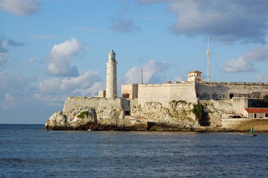 View across the mouth of the harbour in Havana looking towards the landmark Morro Castle and lighthouse. 