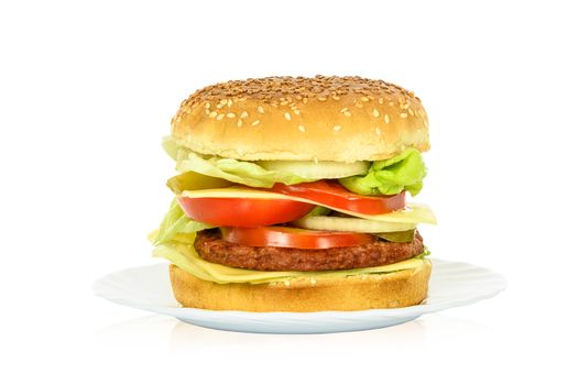 Tasty hamburger, beef burger in close-up on a plate and isolated on white background.