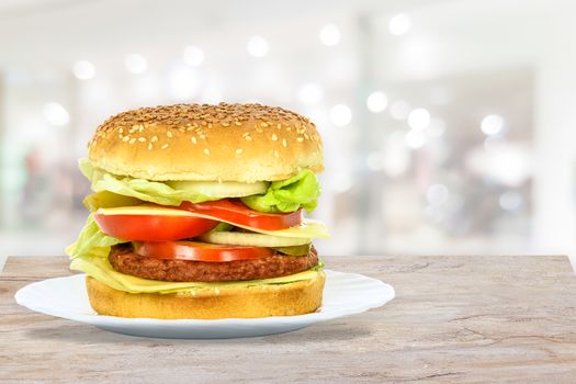 Composite image of tasty hamburger, beef burger in close-up on a plate in the restaurant.