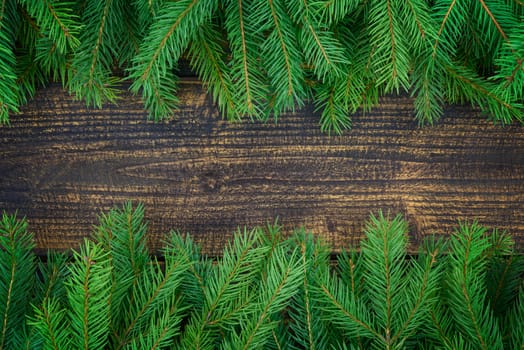 Christmas decoration concept - spruce branches on an old wooden vintage planks with copy space ( high details).