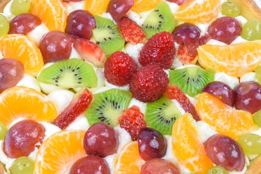 Top view of a multi-fruit cake as a background in closeup.