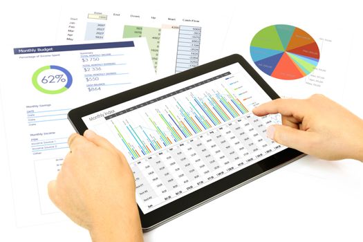 Composite image of businessman analyzing investment charts on the digital tablet at the office.