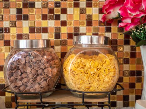 Fruit juice dispensers and coffee & tea water on a self service breakfast counter in a hotel.