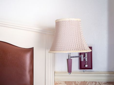 bedroom interior with pillows and reading lamp on bedside table