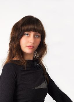 portrait of pretty young girl in black dress in studio