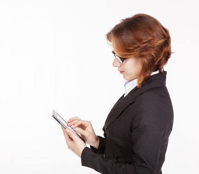 young business woman in black suit and glasses looking at the tablet display