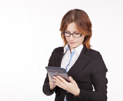 business woman in black suit and glasses looking at the tablet display closeup