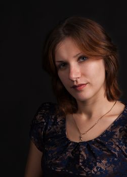 portrait of a young beautiful girl on a dark background