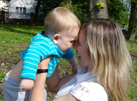 young mother plays with her son in the park