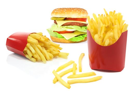 Composite image of fast food products - french fries in red carton boxes and big hamburger isolated on a white background.