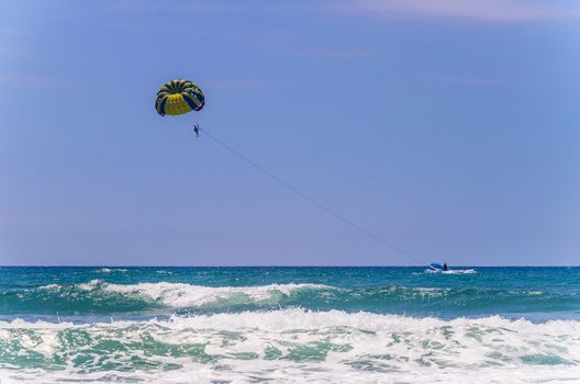 Tourists make their walk on the mountainous beaches in parachute.