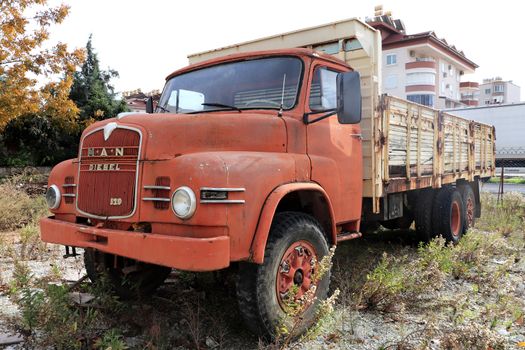 Weathered red retro rusty truck. Vintage aged vehicle.